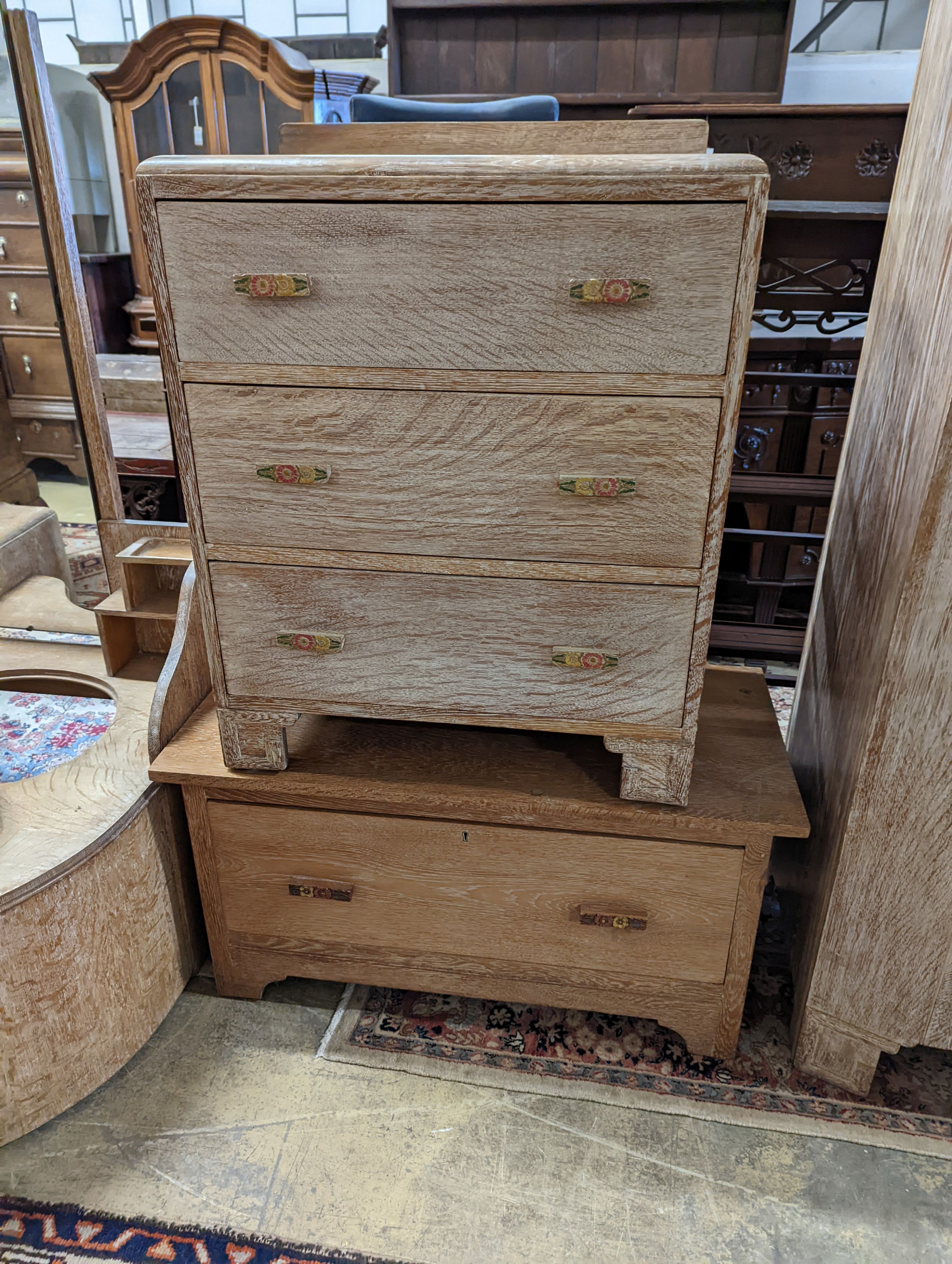 An Art Deco style limed oak three piece bedroom suite and a similar low chest, wardrobe width 108cm depth 51cm height 185cm